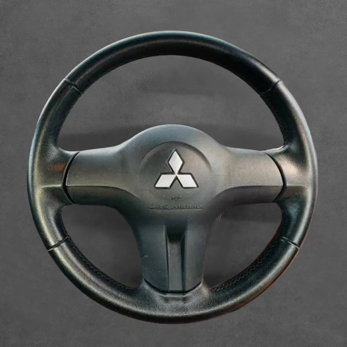 Griffowl Steering Wheel Cover for Customized Sedan Mitsubishi Lancer 2006-2008. For refined interior upgrades using our wrap and stitch kit.